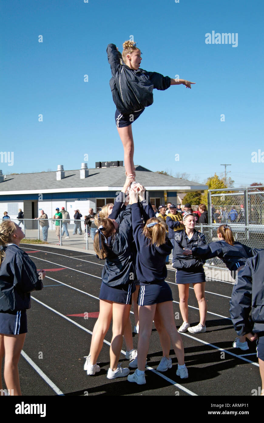 High School cheerleaders perform complicated and sometimes dangerous maneuvers during