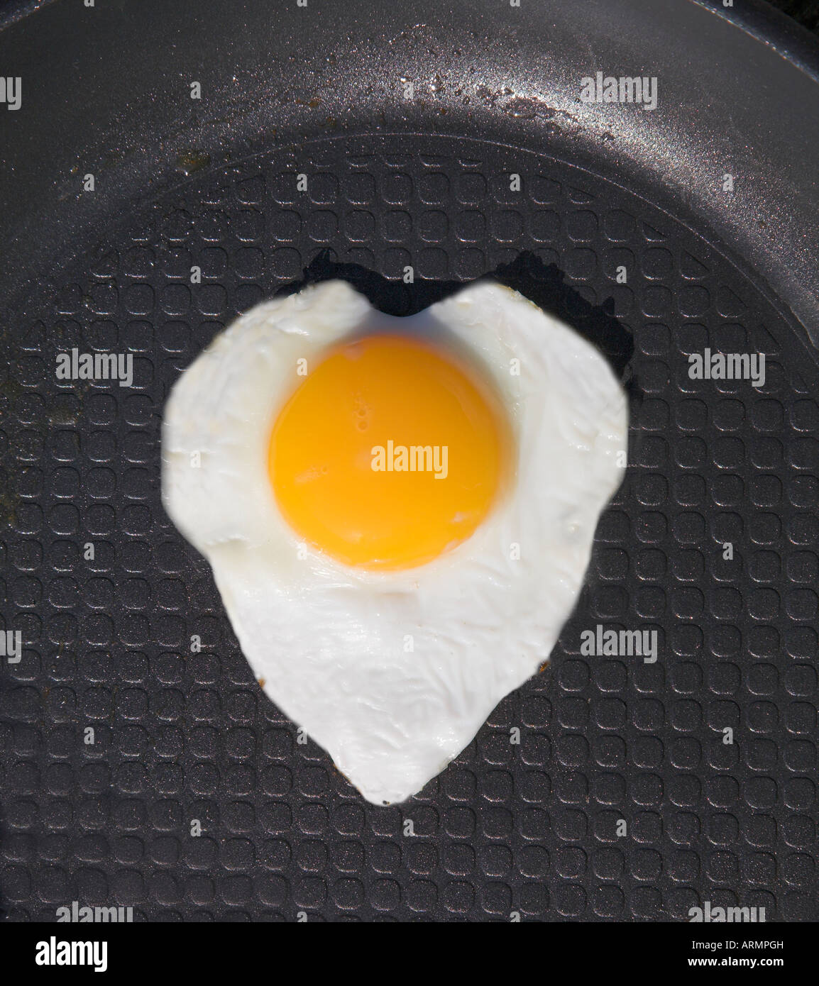 Fried egg in a frying pan shaped like a heart Stock Photo - Alamy