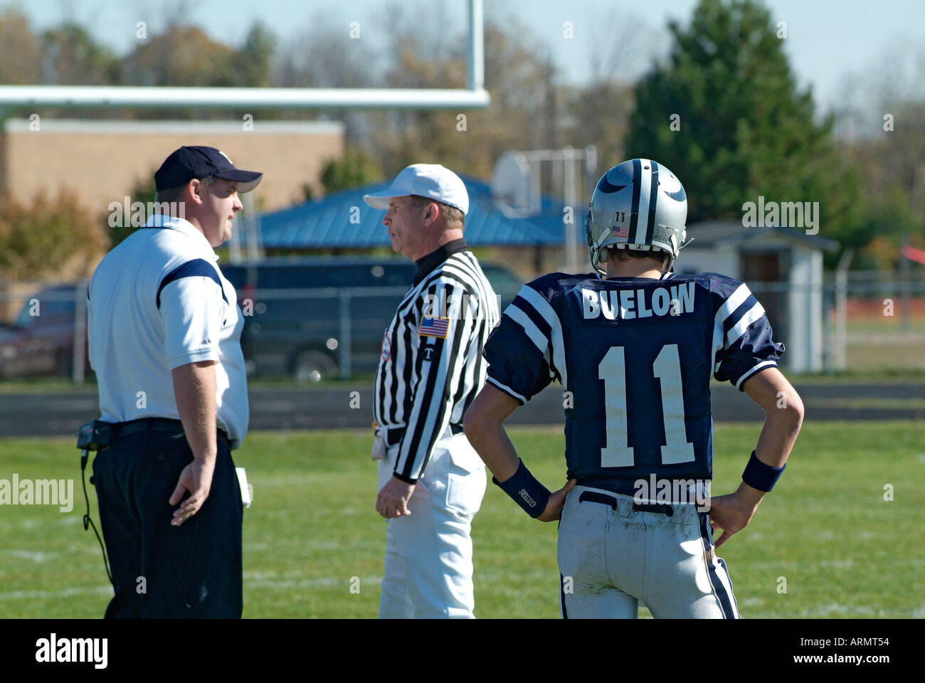 High School football action as coach argues with umpire official about the outcome of a certain call play Stock Photo