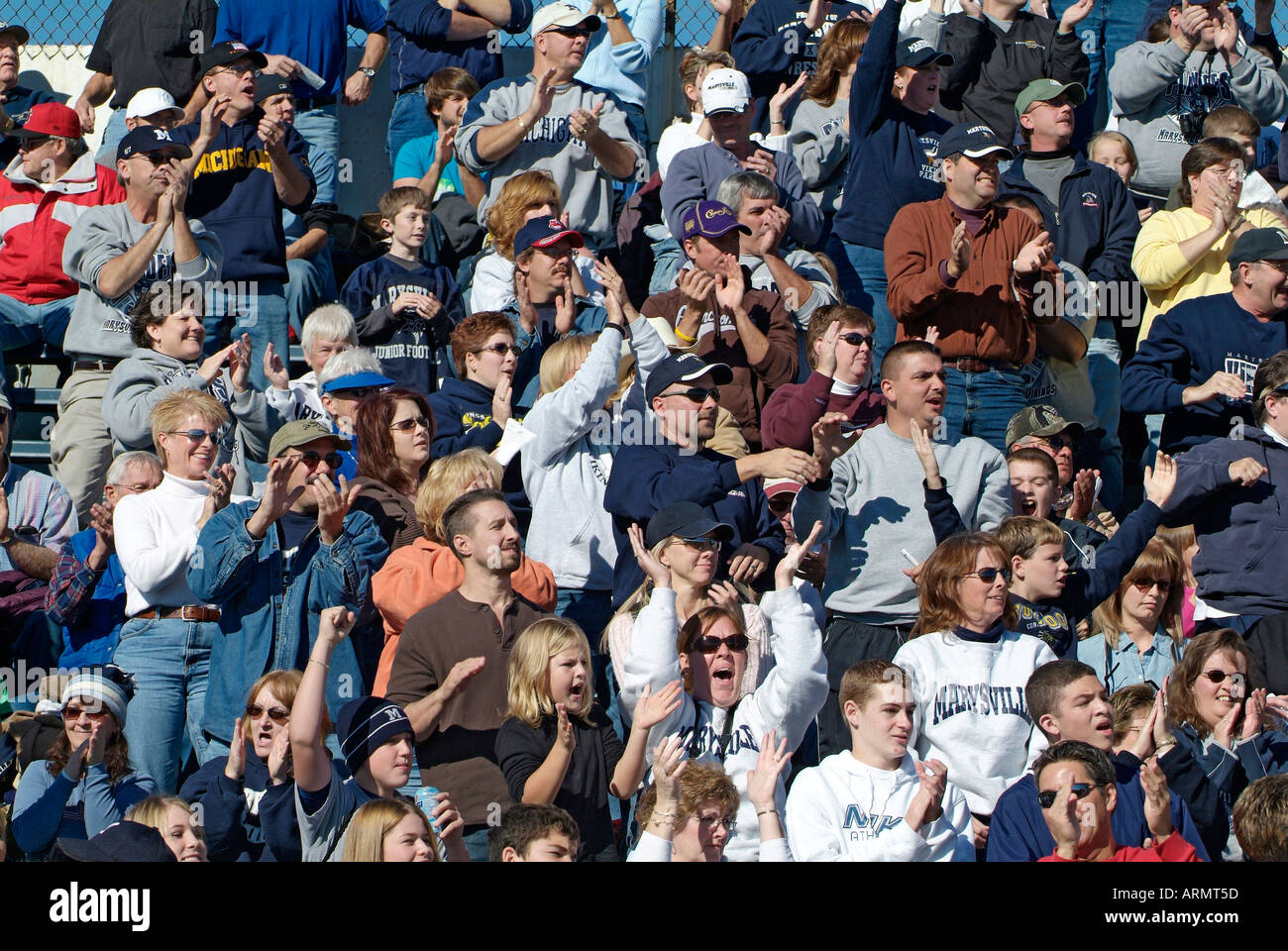 Crowd of people friends and family cheer and support a high school football team Stock Photo