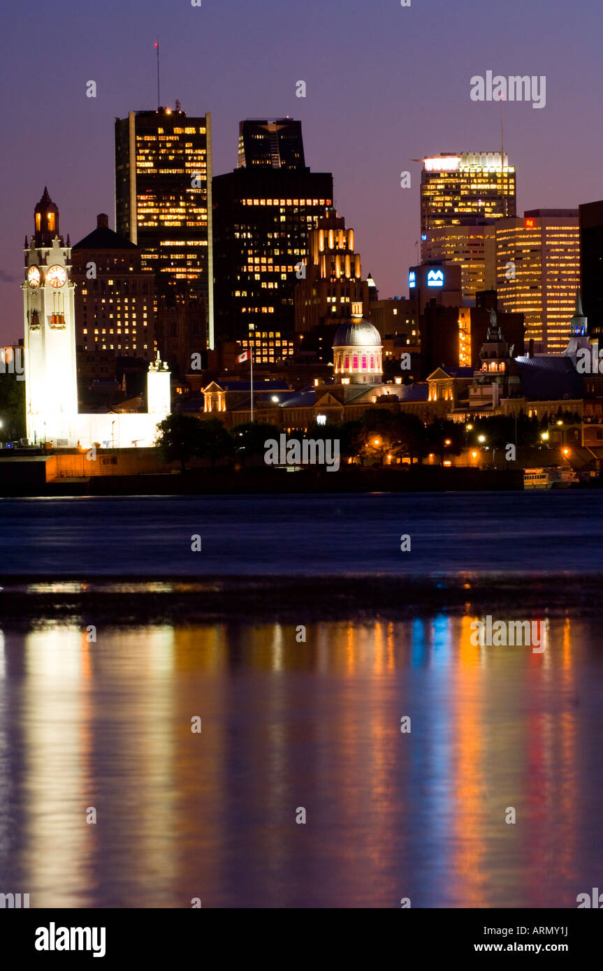 Evening view of skyline with old Montreal in foreground, across St. Lawrence River from Ile Notre-Dame, Montreal, Quebec, Canada Stock Photo