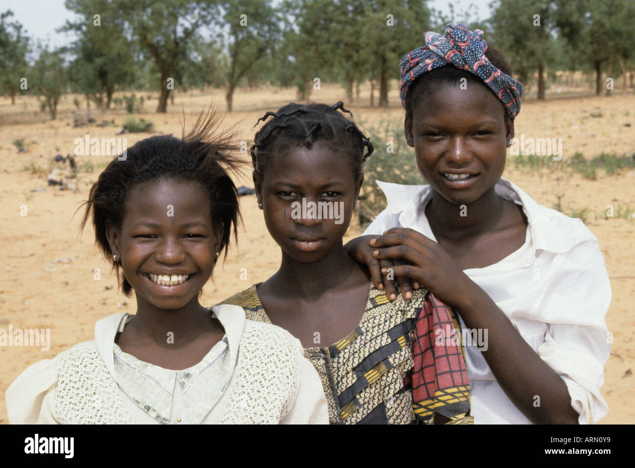 Niamey, Niger, West Africa. Three Nigerien Girls. Young Women, two with Facial Tattoos Denoting Tribal Affiliation. Stock Photo