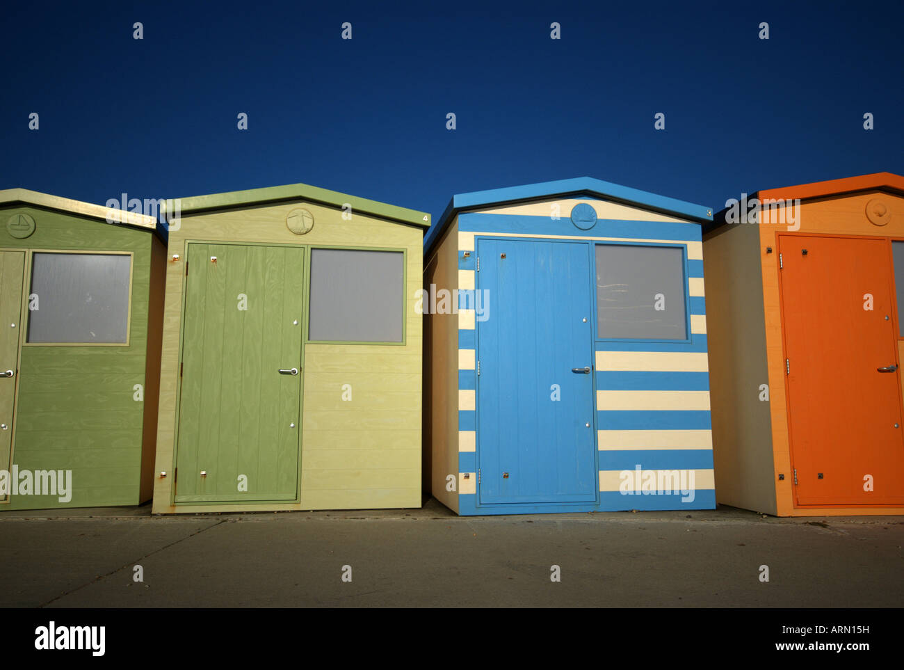 Brightly coloured beach huts closed and out of season at Seaford, Newhaven, Kent, UK. Stock Photo