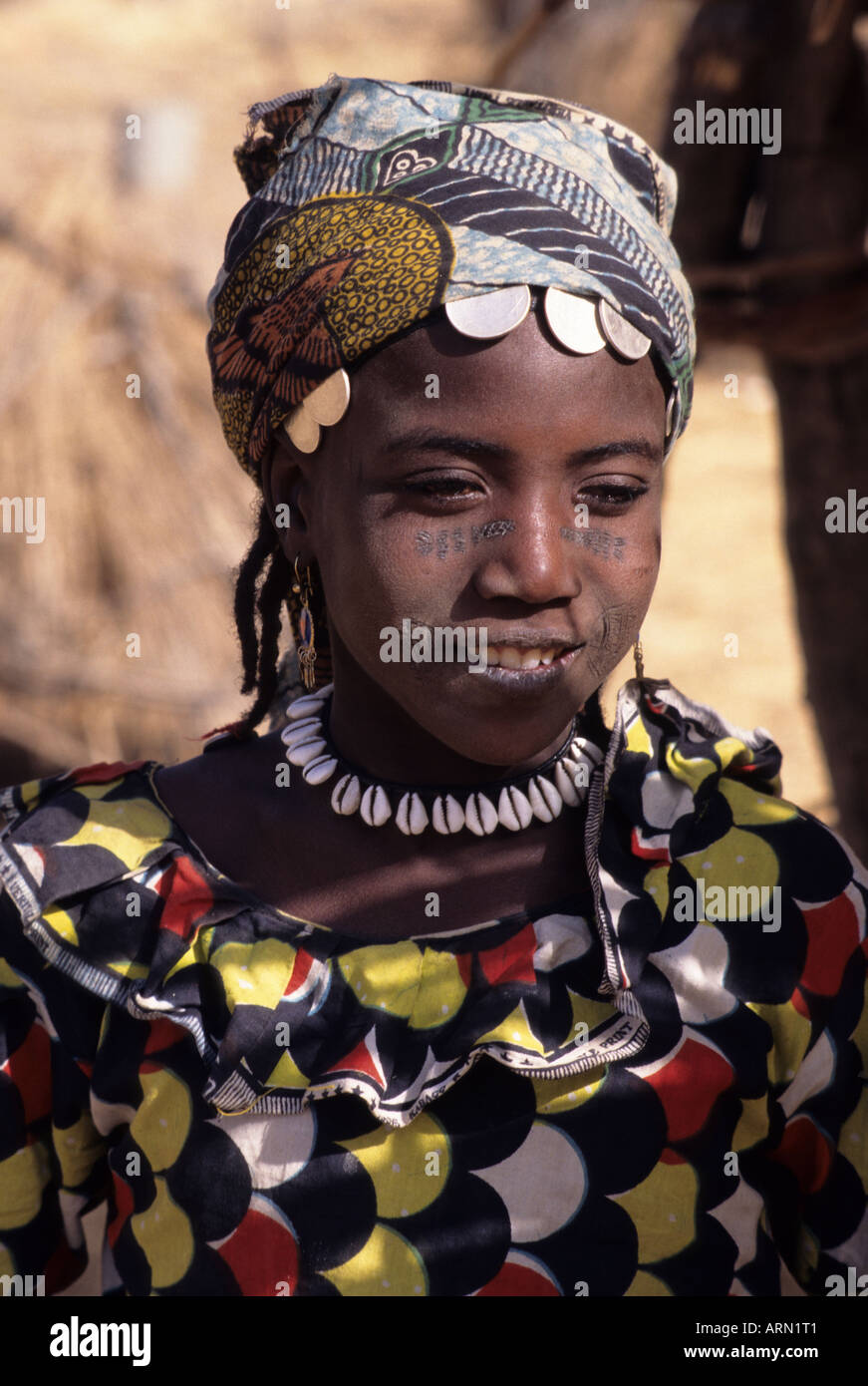 Kankamtuti, Niger, Africa. Fulani Girl with Facial Tattoos, Scarification. Cowrie Shell Necklace and  Coins as Jewelry. Stock Photo