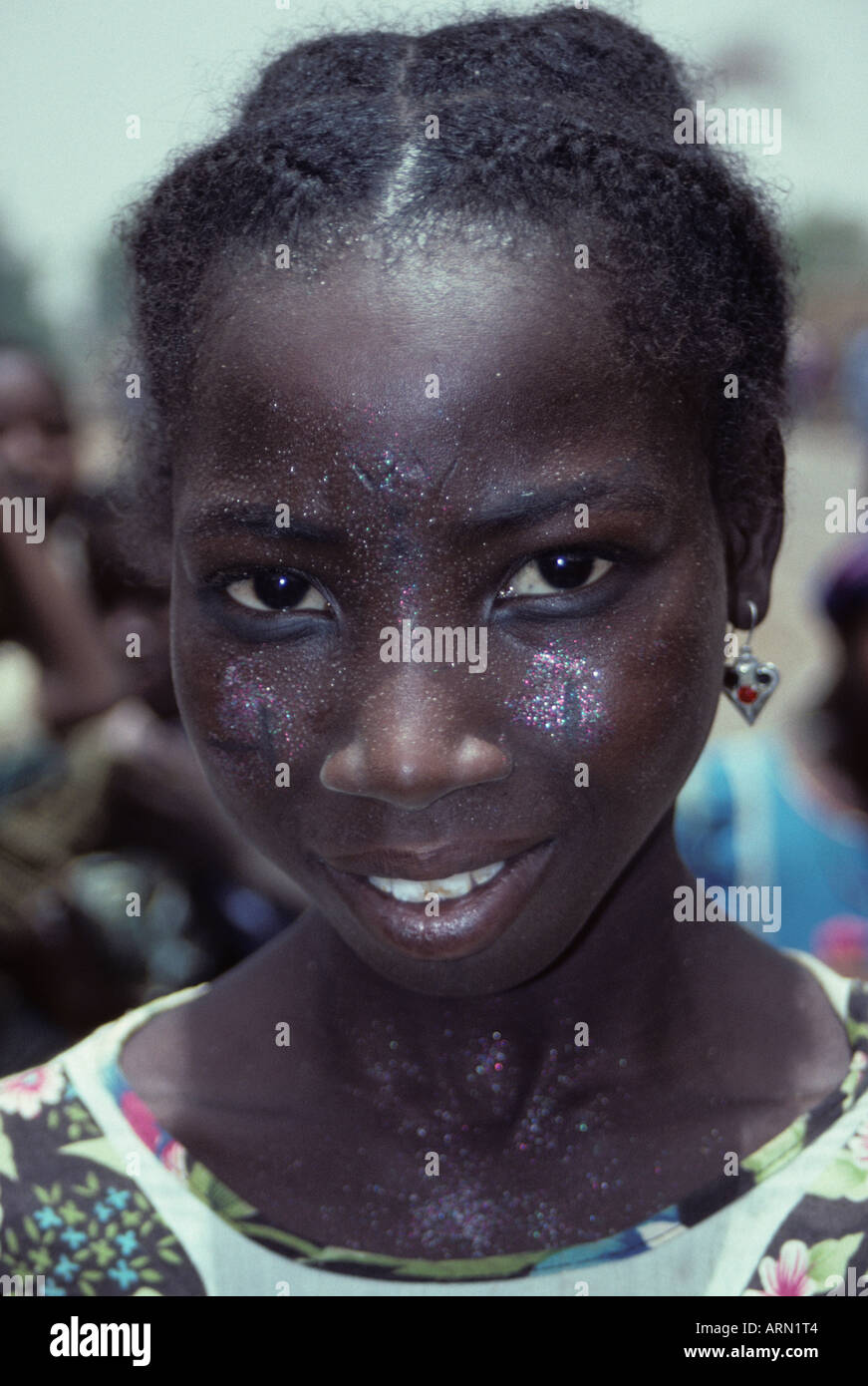 Bonkoukou, Niger, Africa. Nigerien Girl with Sprinkles or Glitter on Face, plus Facial Tattoos, Scarification. Stock Photo