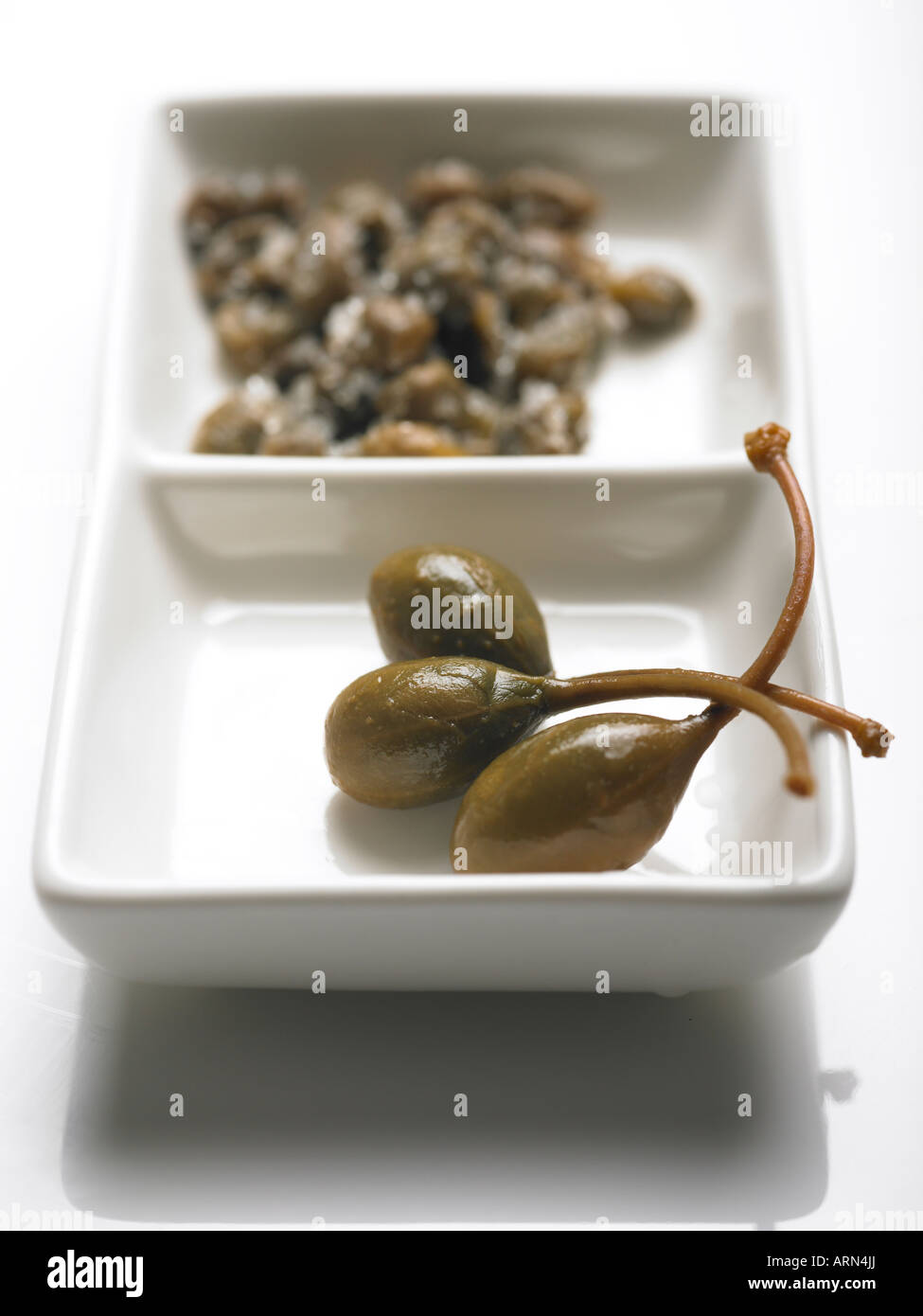 caper berries and salted capers from plant Capparis spinosa Stock Photo Alamy