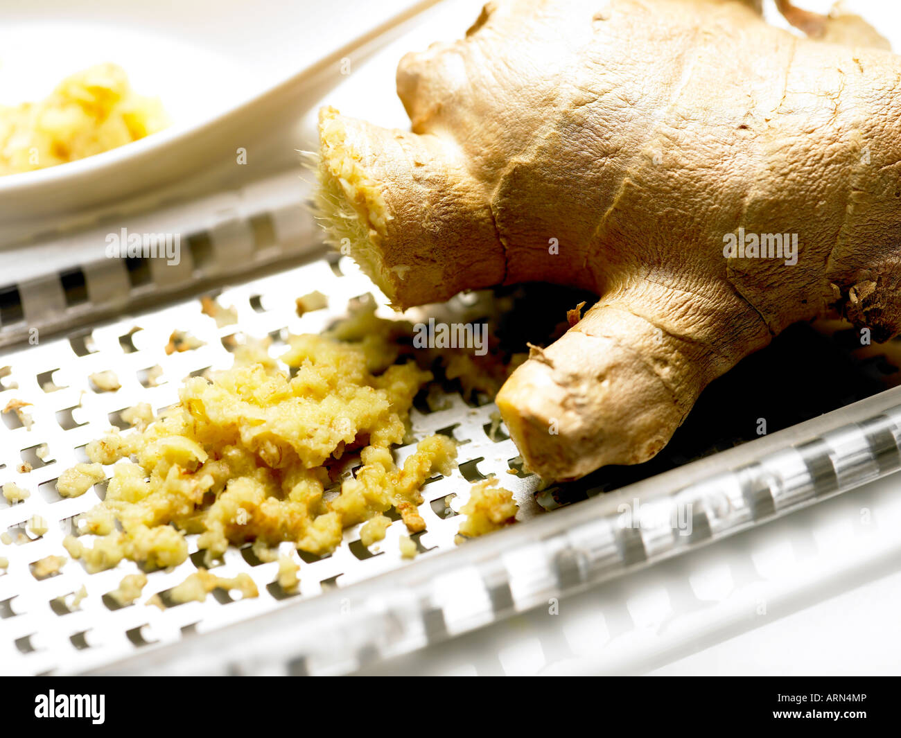 grated root ginger stem and grater Stock Photo Alamy