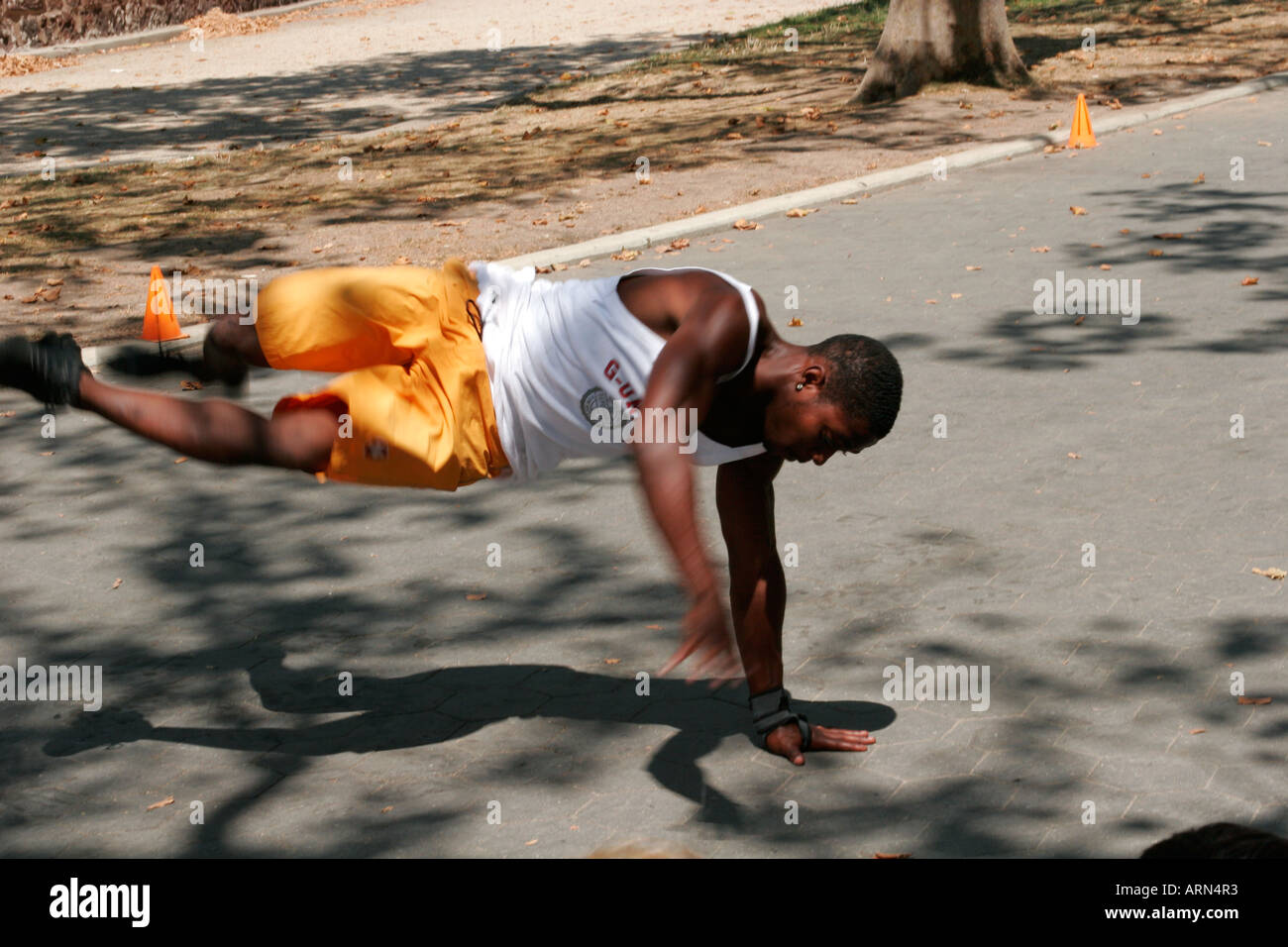 Break-dancer performing a handstand move in Battery Park, New York City, summer 2006. Stock Photo
