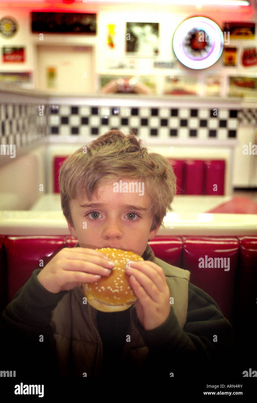boy eating hamburger in burger sixties dinner Stock Photo Alamy