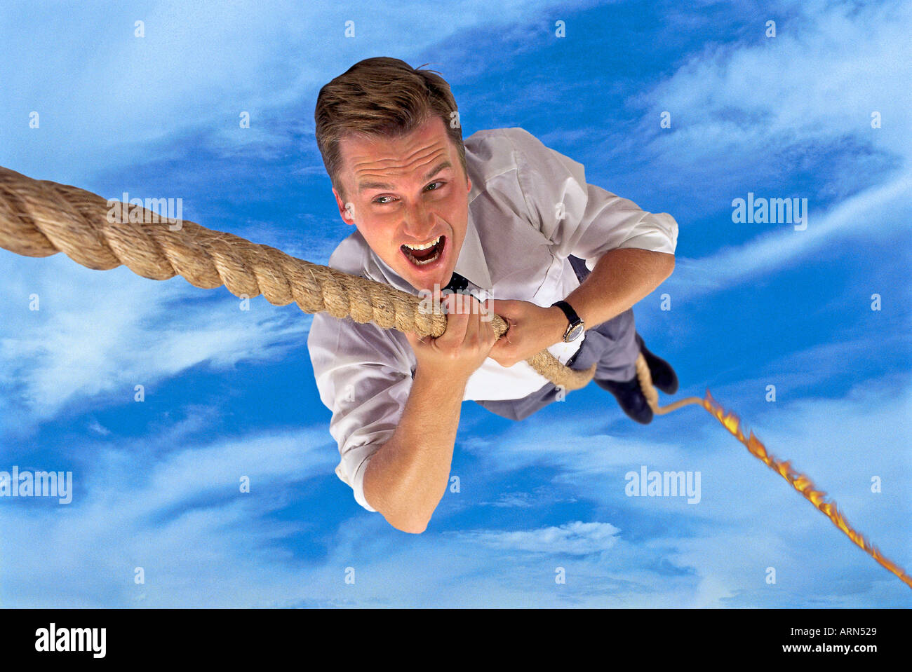 man climbing ropebusinessman climbing rope Stock Photo Alamy