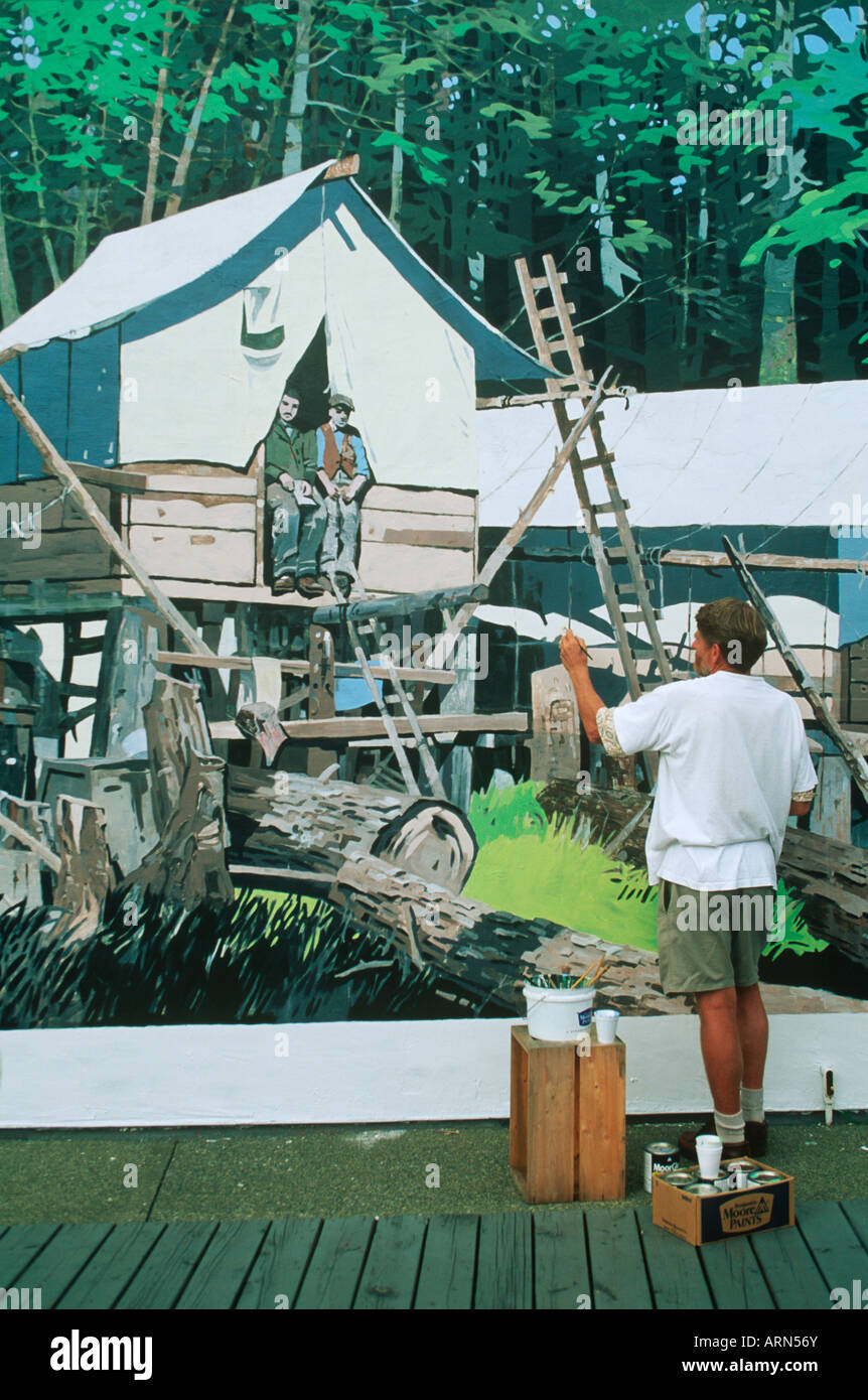 Artists repairs his mural, Chemainus (town of murals), Vancouver Island