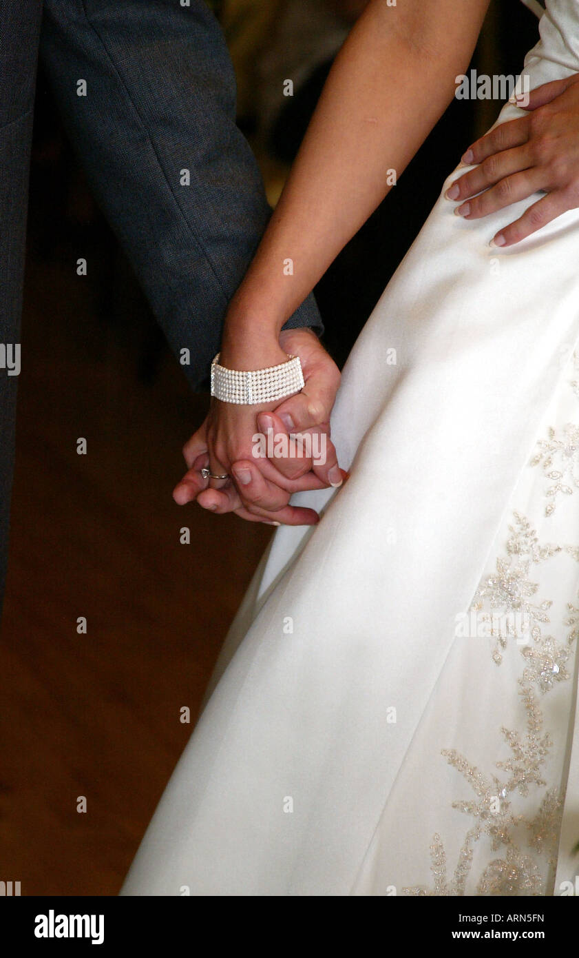 A Bride and Groom hold hands while taking their vows at their civil wedding ceremony Stock Photo