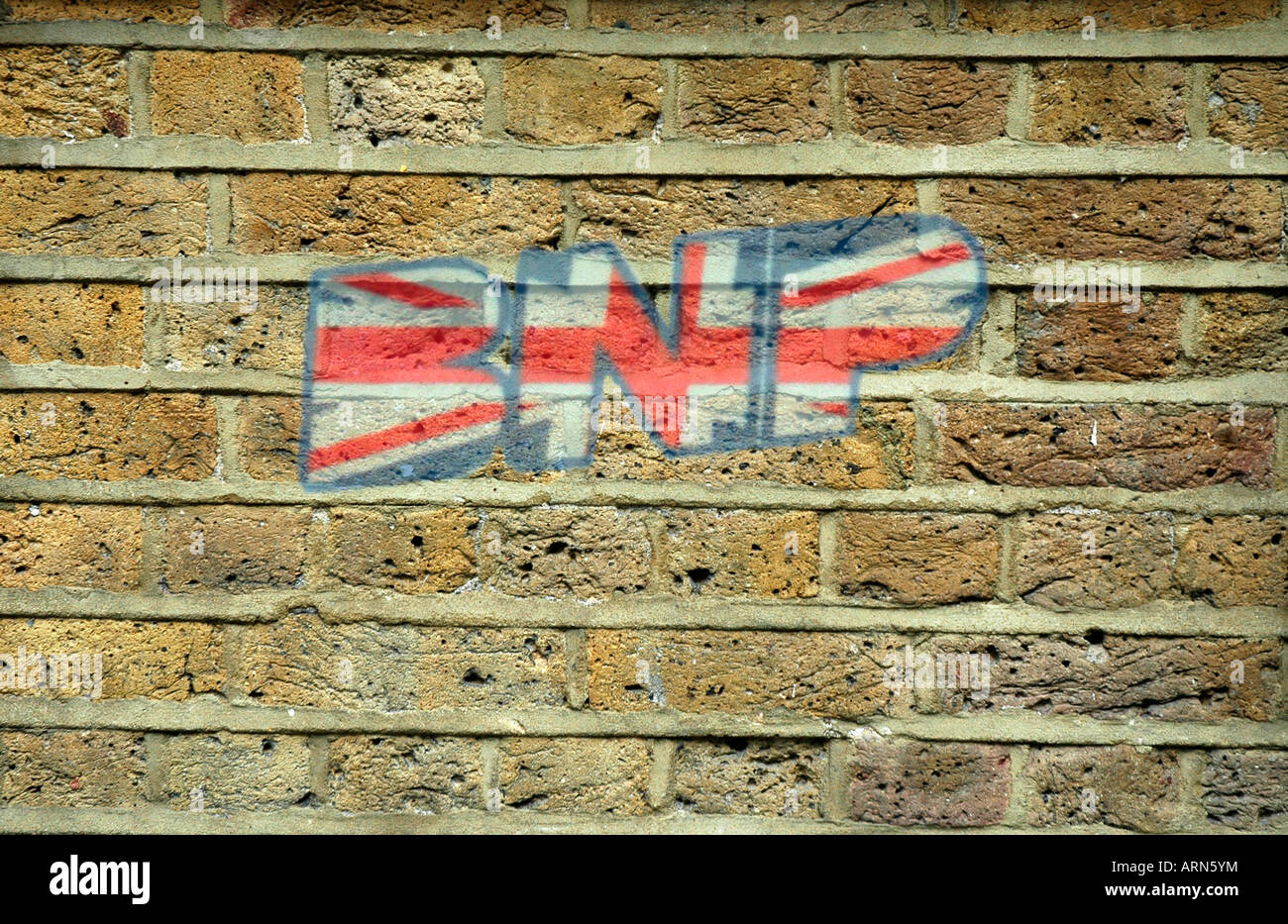 British National Party Graffiti on a Brick Wall. Stock Photo