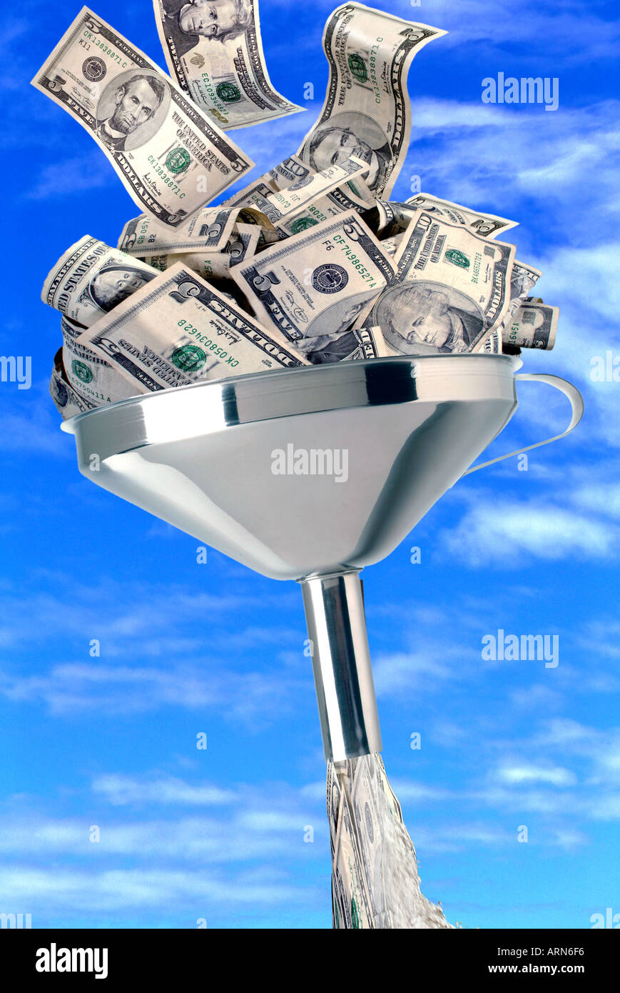 Money flowing through funnel Stock Photo