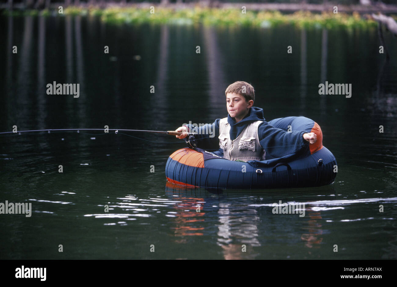 boy fly fishing from float tube in small lake, British Columbia, Canada  Stock Photo - Alamy