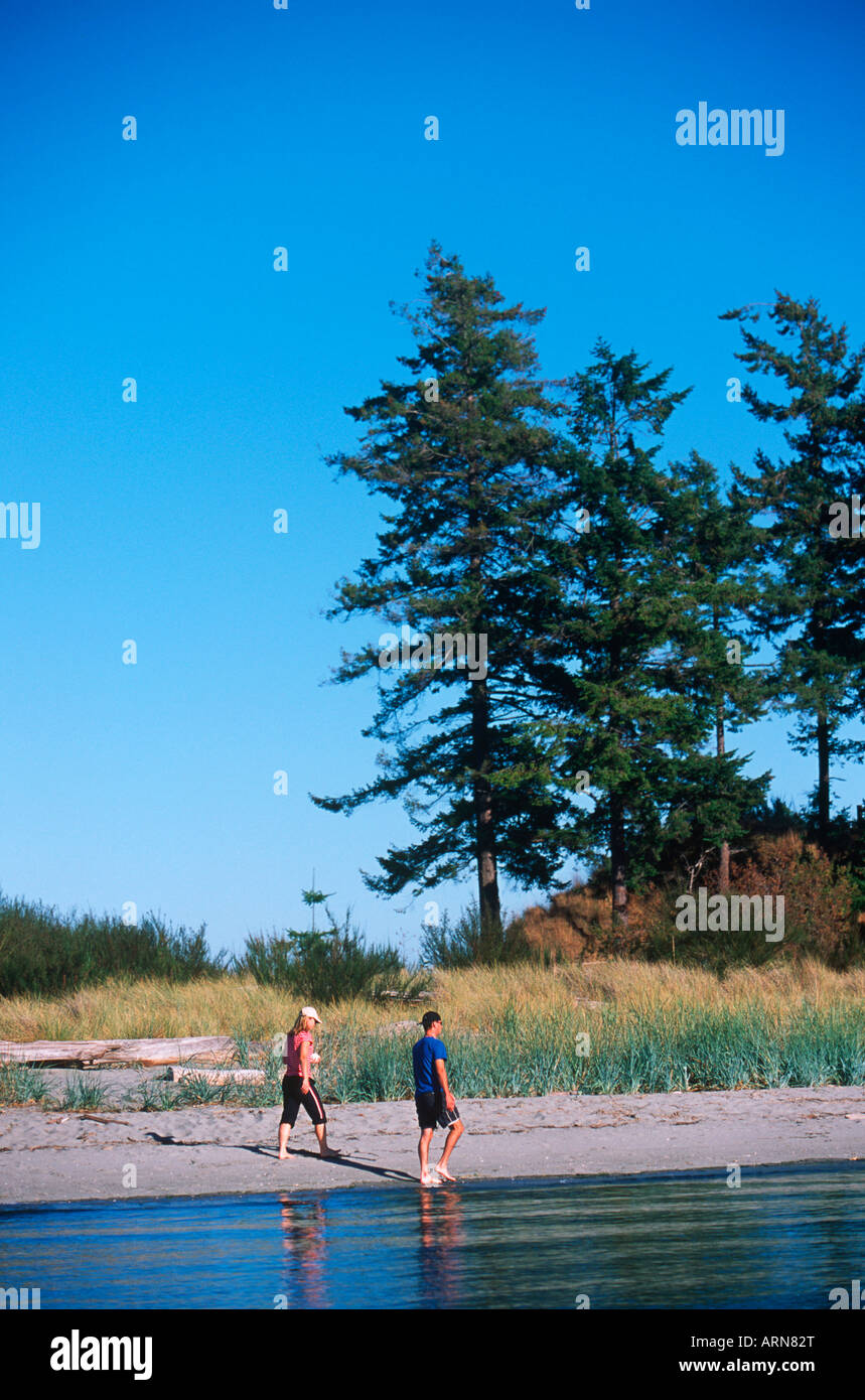 Sidney Spit , Gulf Islands National Park, people walk beach, British Columbia, Canada. Stock Photo