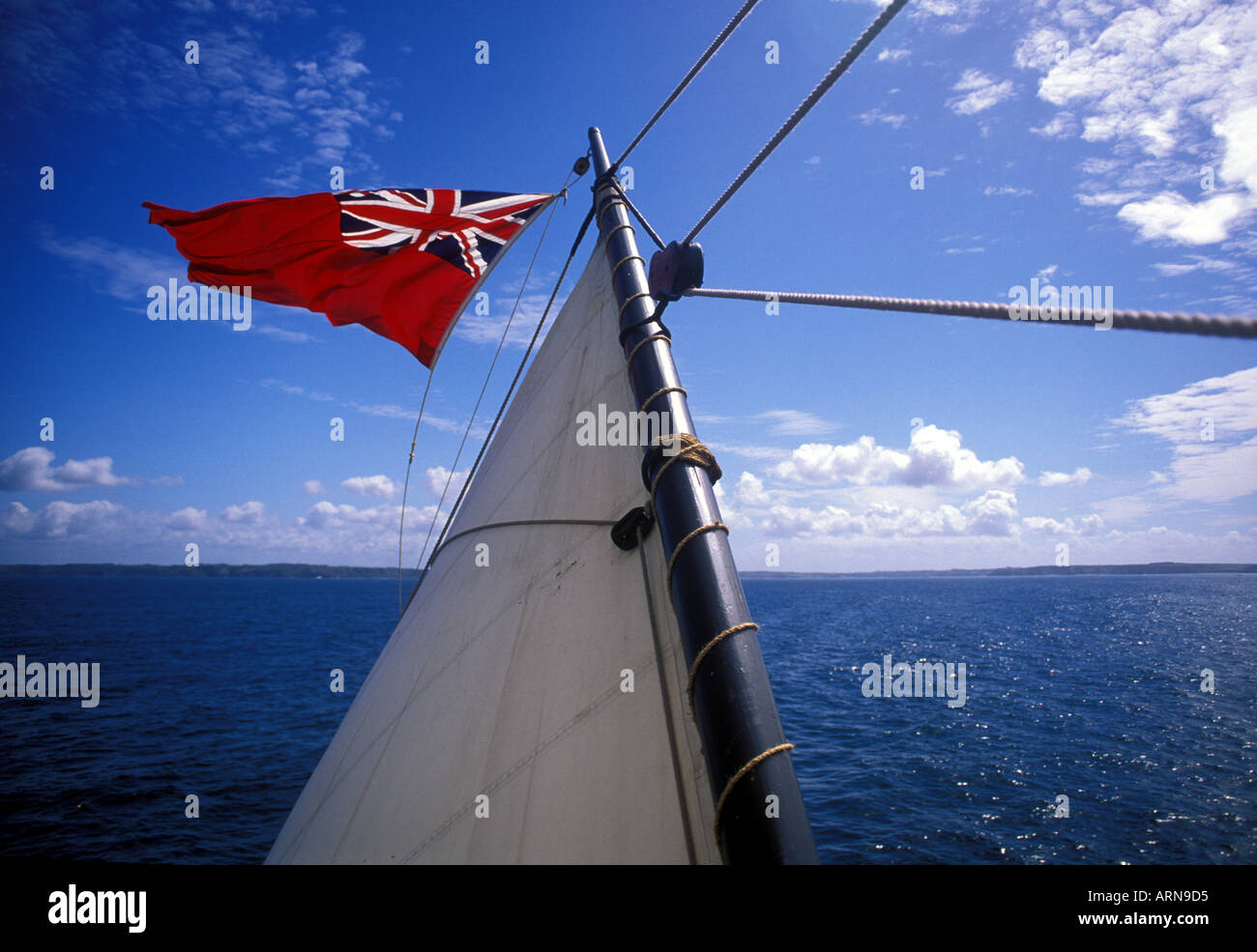 Sail and ensign fly over the horizon Tall ship Phoenix  Stock Photo