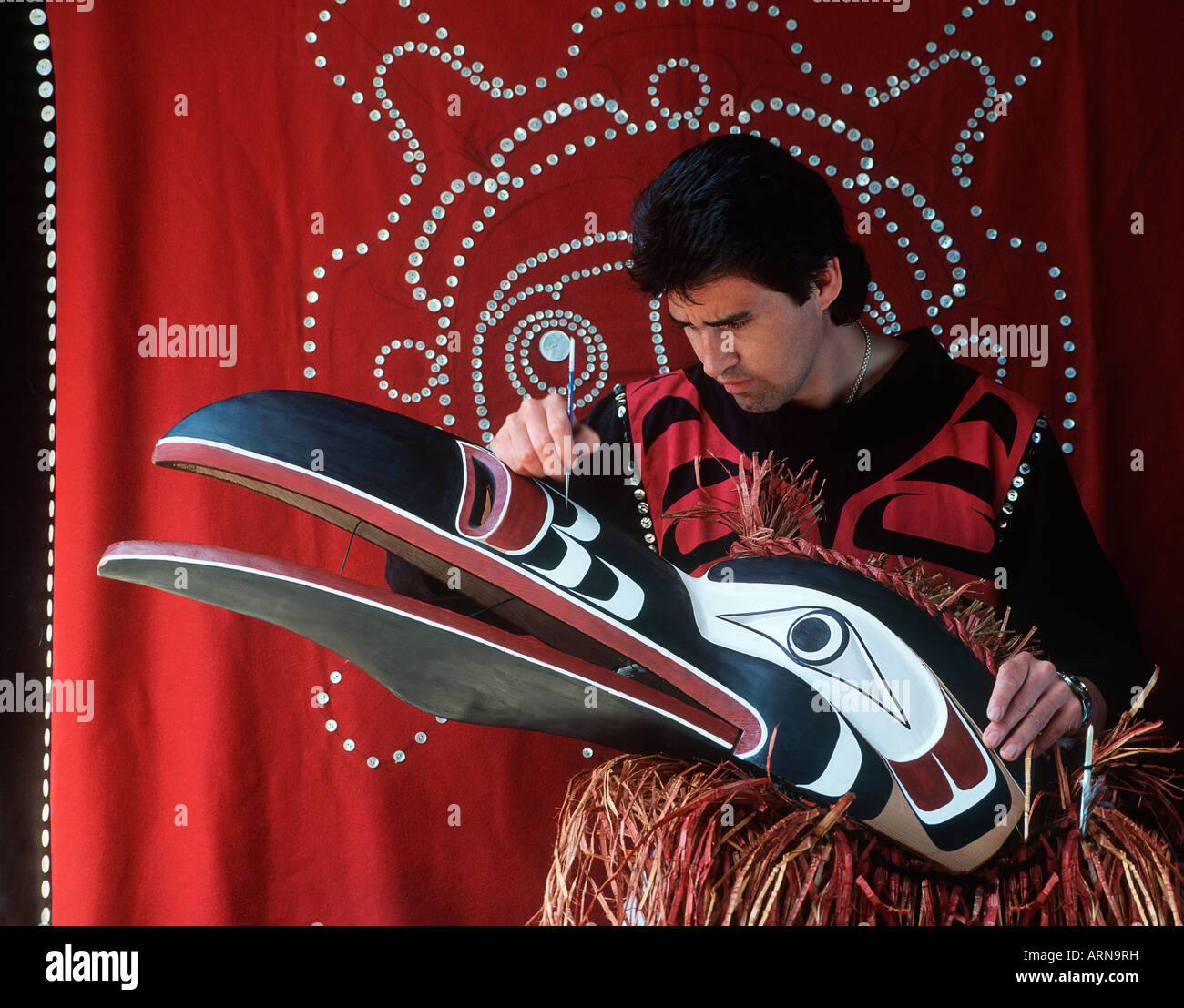 kwakwaka'wakw artisan paints ceremonial mask, Vancouver Island, British Columbia, Canada. Stock Photo