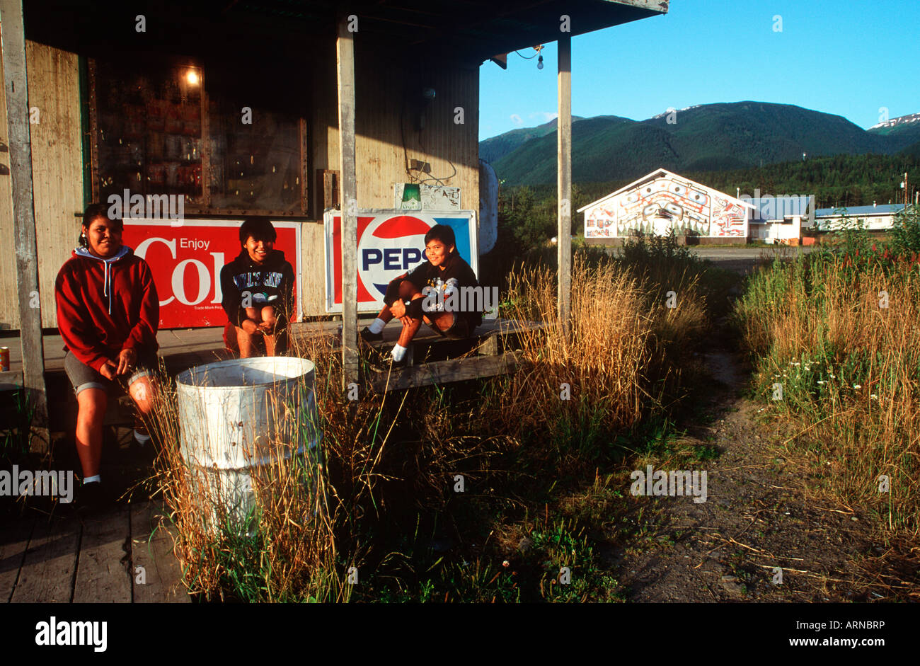 Nass River Valley, school girls on storefront porch in New Aiyanch, British Columbia, Canada. Stock Photo
