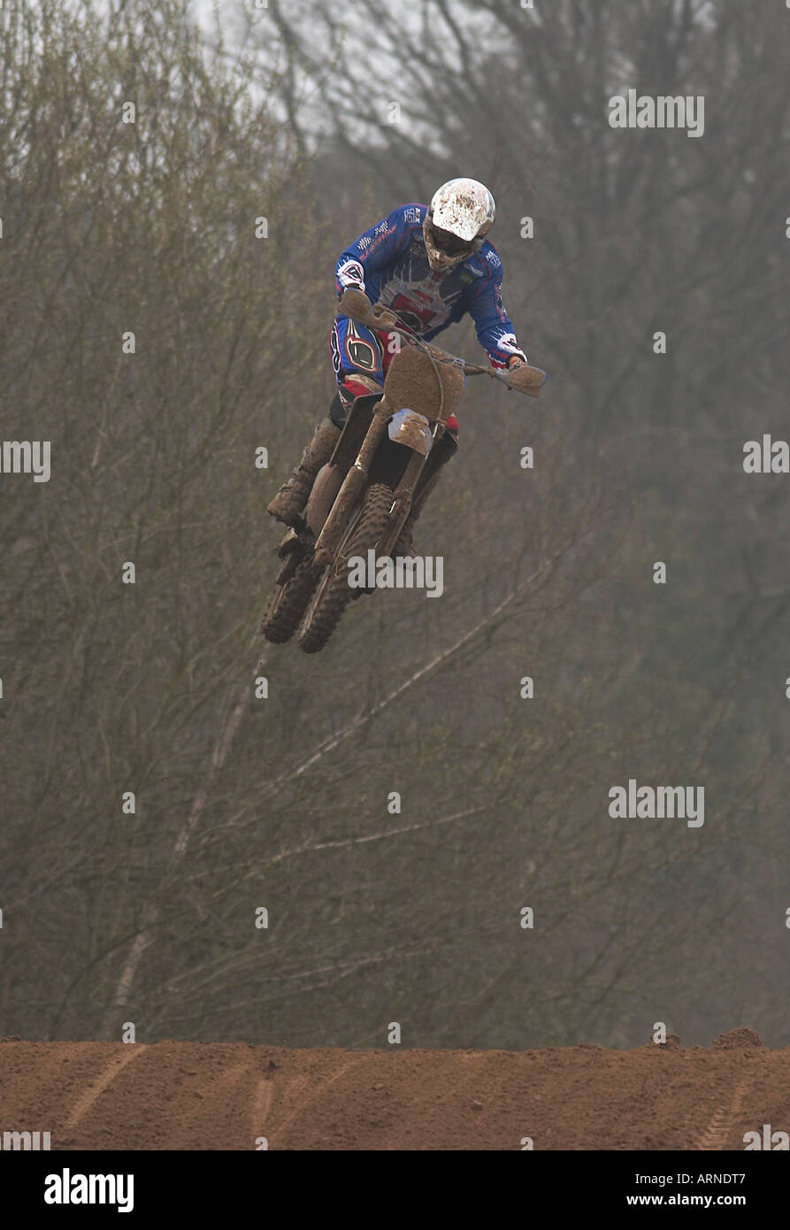 Jumping motocross driver Stock Photo - Alamy