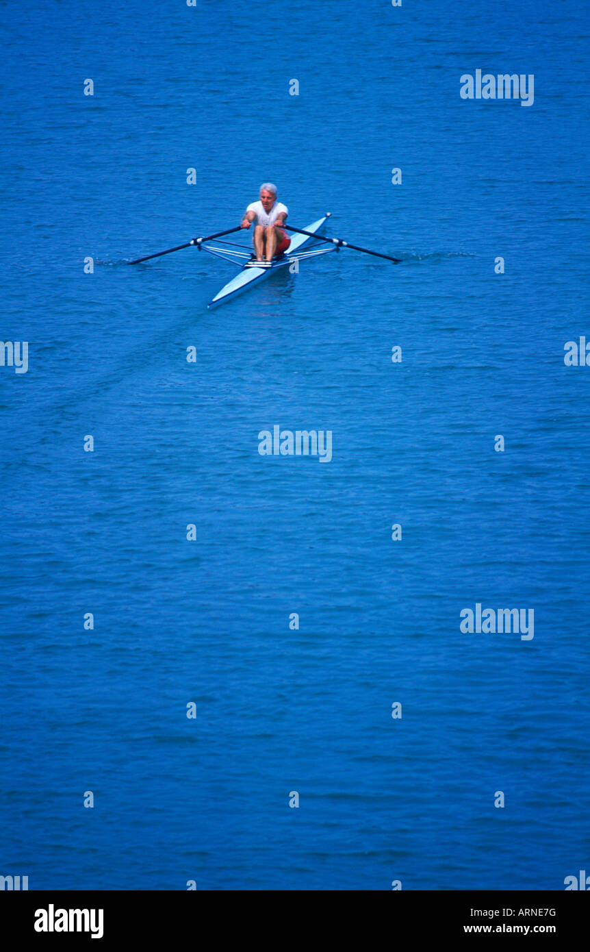 Older man in single rowing shell, British Columbia, Canada. Stock Photo