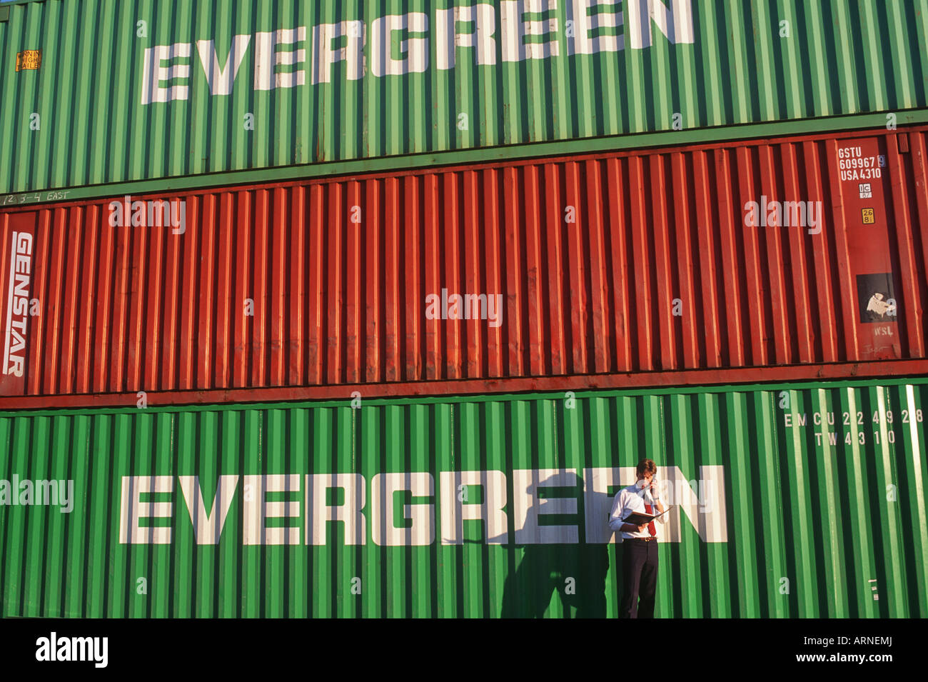 Vancouver port worker checks documents in container storage area