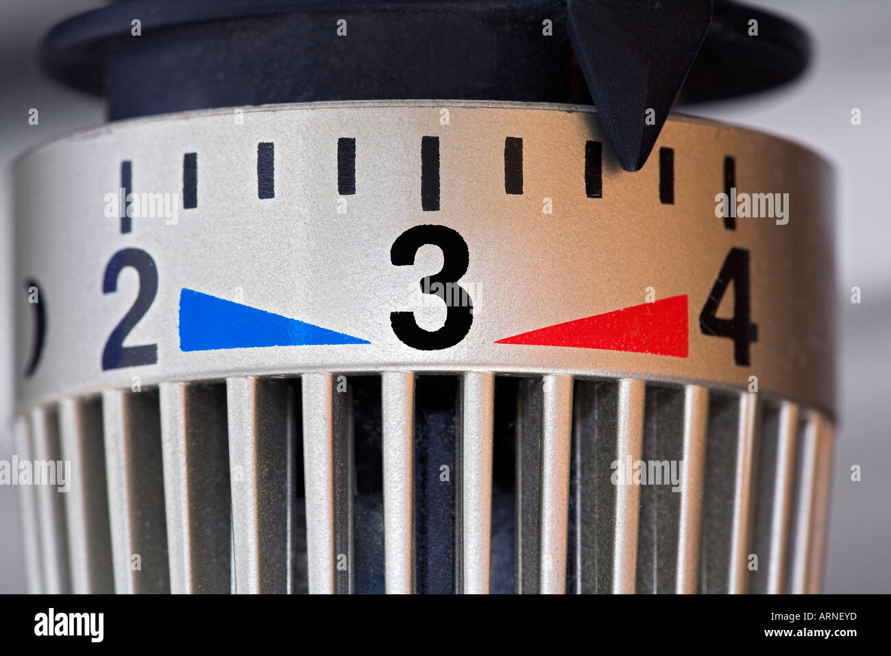 Thermostat of a radiator, markings for warm and cold, symbol for energy