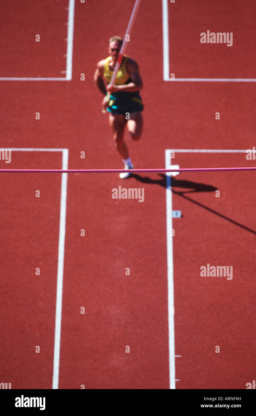 Track and field competition, pole vaulter on rust coloured track, British Columbia, Canada Stock