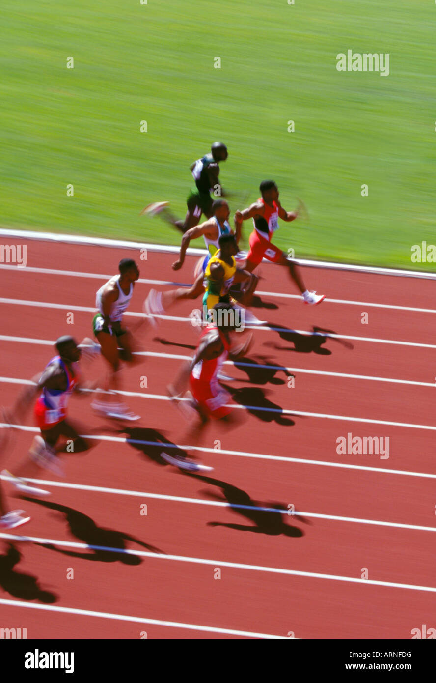 100 M men's sprint at track competion. Motion blur, rust track, British Columbia, Canada. Stock Photo