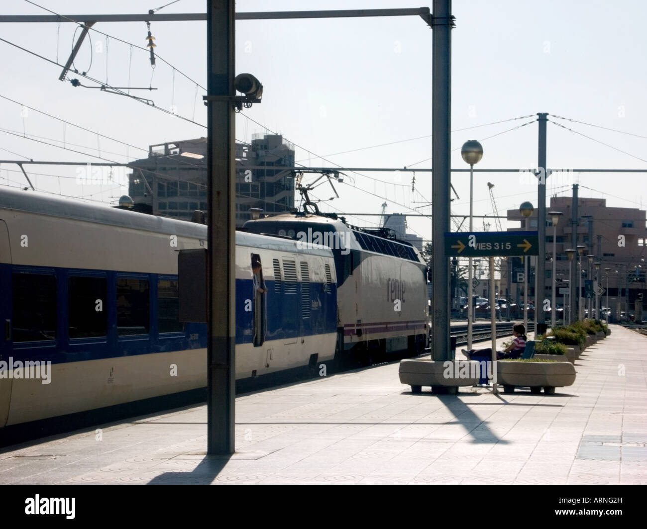 Tarragona railway station with local Renfe train and guard, Catalonia