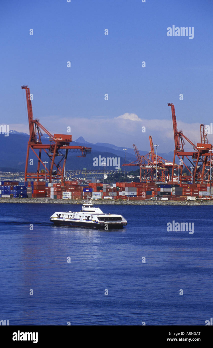 Seabus Seabus crossing the Burrard Inlet with cargo ship cranes beyond. The ...