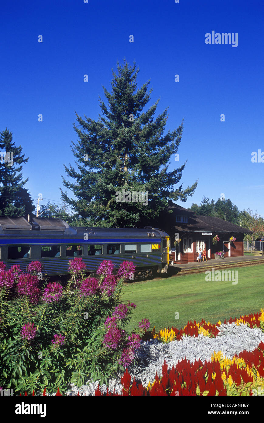 Qualicum Beach, E & N railway station with train arriving, Vancouver Island, British Columbia, Canada. Stock Photo