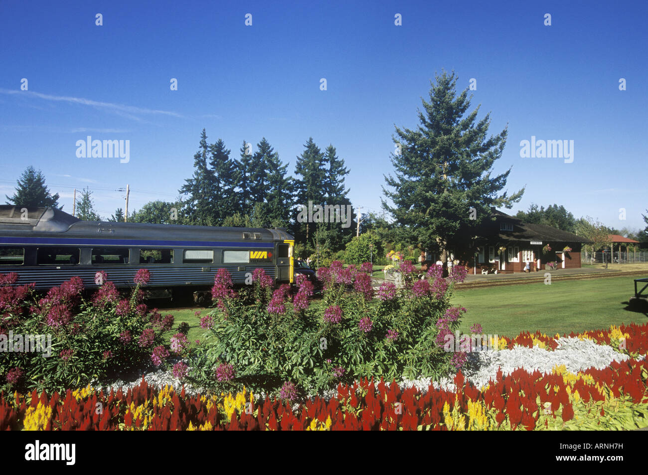 Qualicum Beach, E & N railway station with train arriving, Vancouver Island, British Columbia, Canada. Stock Photo