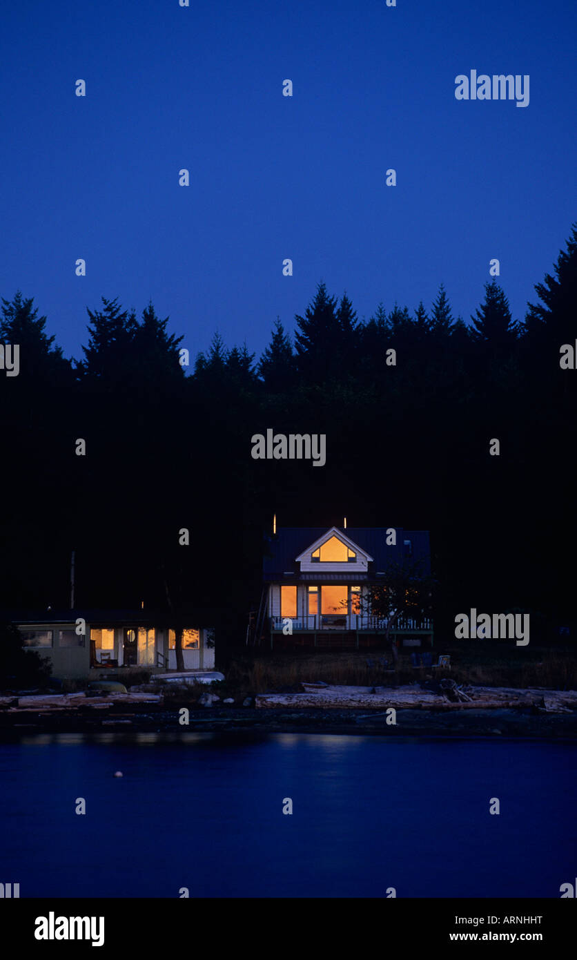 Gabriola Island Beachfront homes glow at dusk, British Columbia, Canada. Stock Photo