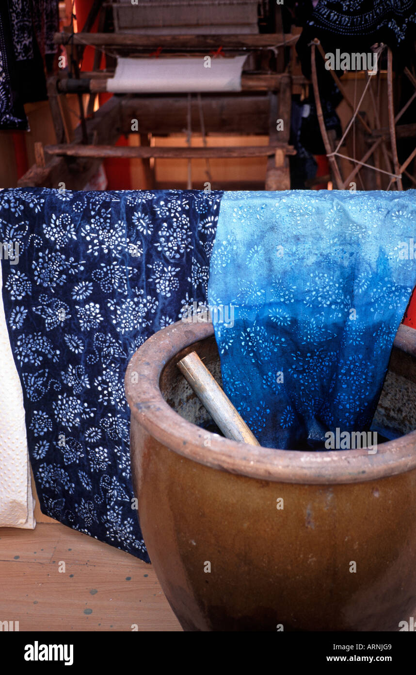 Hand dyeing blue and white fabric printed by hand with a wood block in