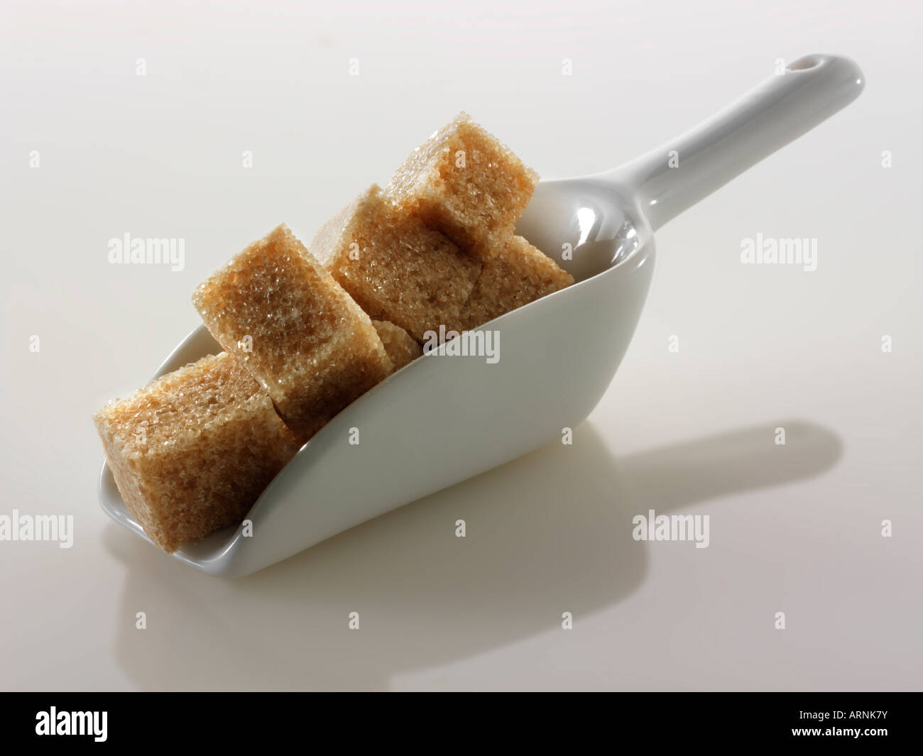 Demerara cut sugar cubes still life against a white background Stock