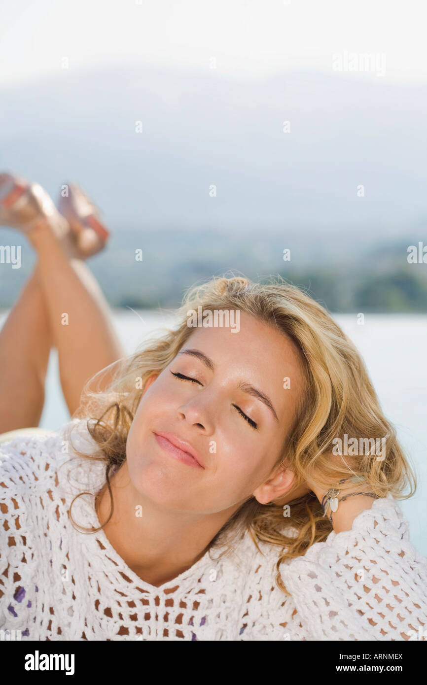 Woman relaxing by a pool Stock Photo