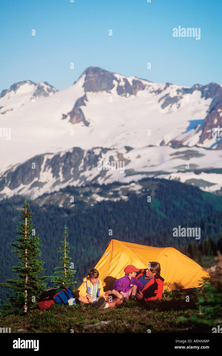 family by gold tent in alpine, Whistler, British Columbia, Canada. Stock Photo