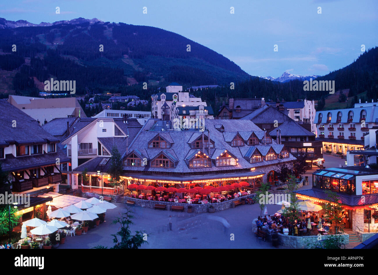 Whister village at dusk with mountain beyond, Whistler, British ...
