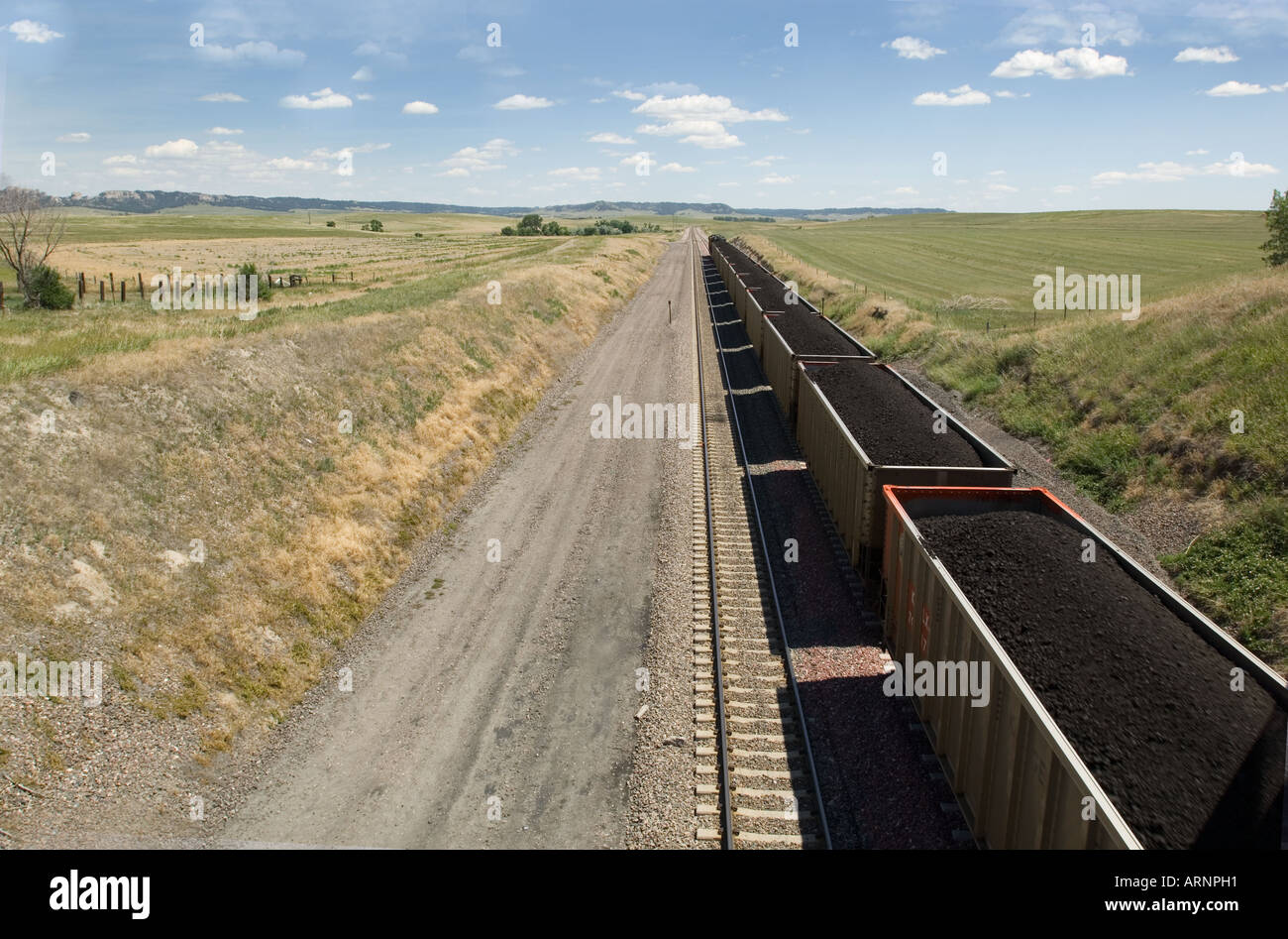 Railroad cars filled with coal traveling on train tracks near Chadron