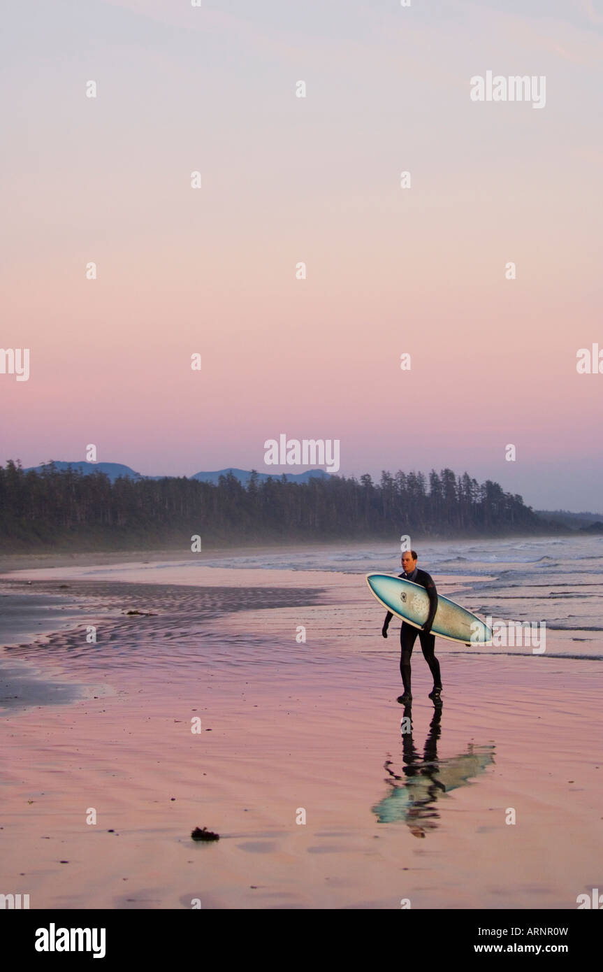 Pacific Rim Walk In Sea surfer walks shoreline, Pacific Rim National Park, Long Beach ...