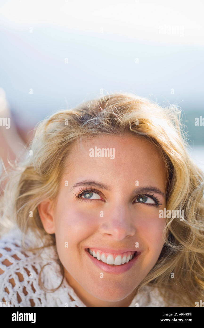 Woman relaxing by a pool Stock Photo
