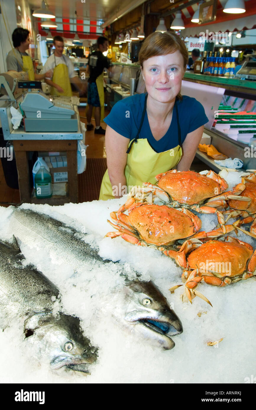 A seafood vender at the granville island market hires stock