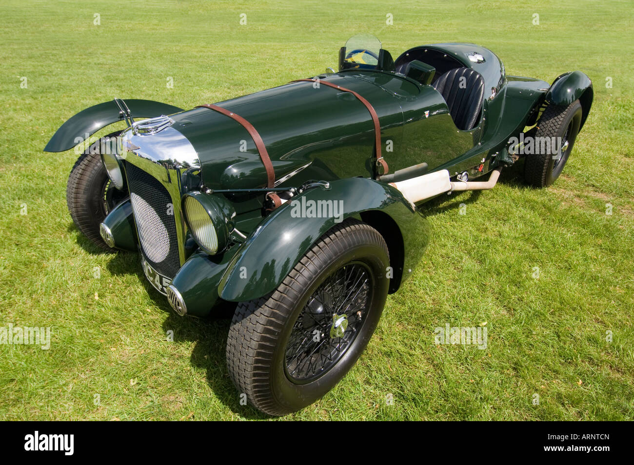 A historic British racing green 1939 Lagonda V12 Le Mans motor car stood on grass Stock Photo