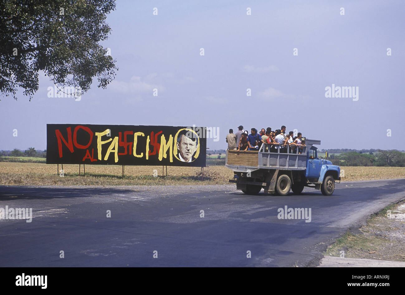 Cuba, rural area outside of Havana, anti american sign and collective transport in triuck Stock Photo