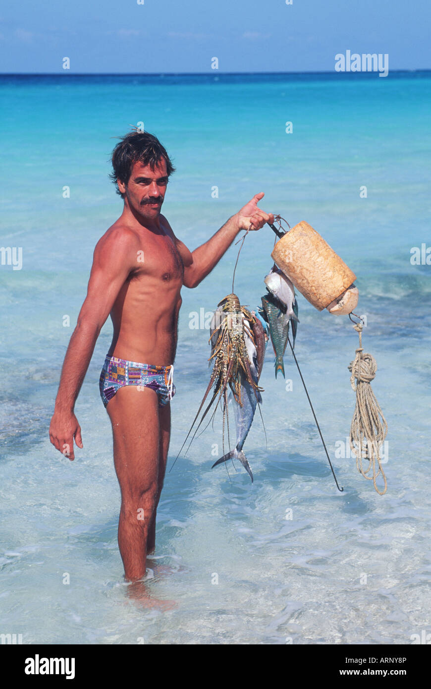 Cuba, Veradaro,  local diver displays fresh caught seafood on beach Stock Photo