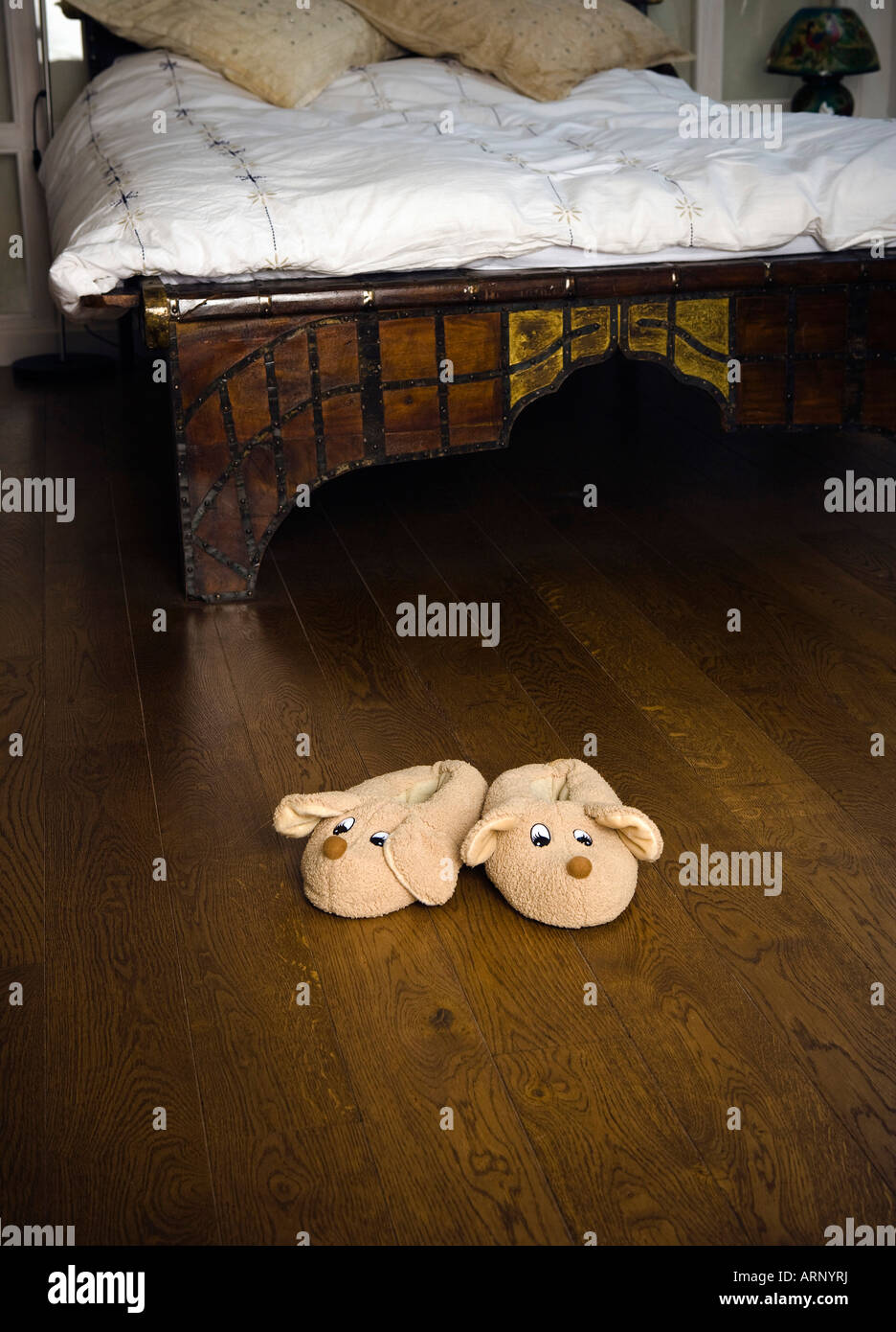 Slippers on bedroom floor Stock Photo