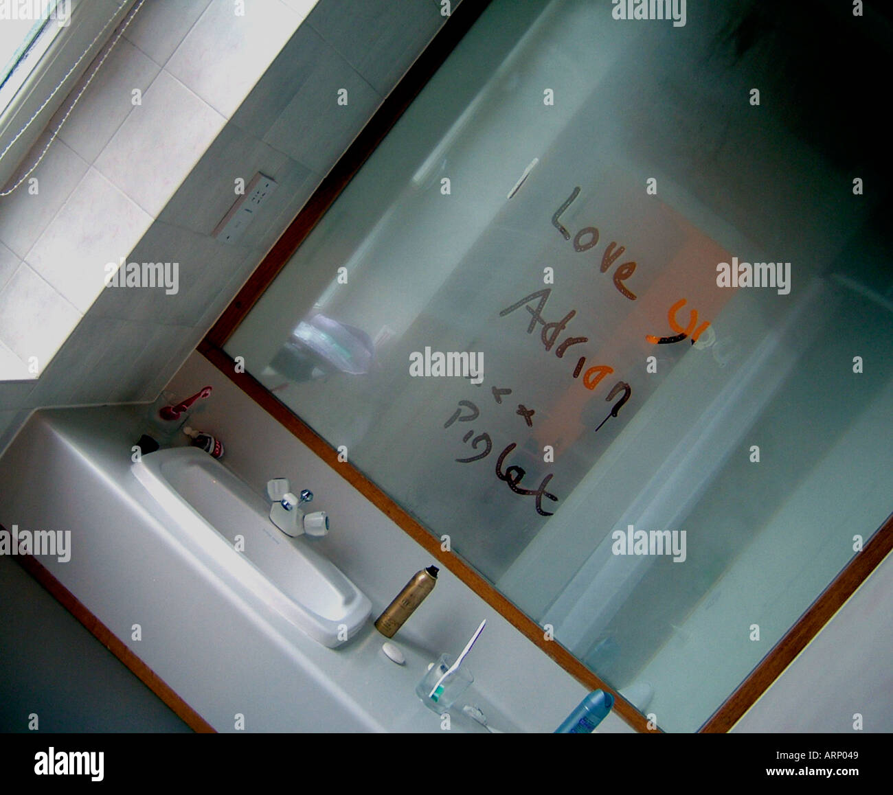 message on steamed up misty mirror Stock Photo Alamy