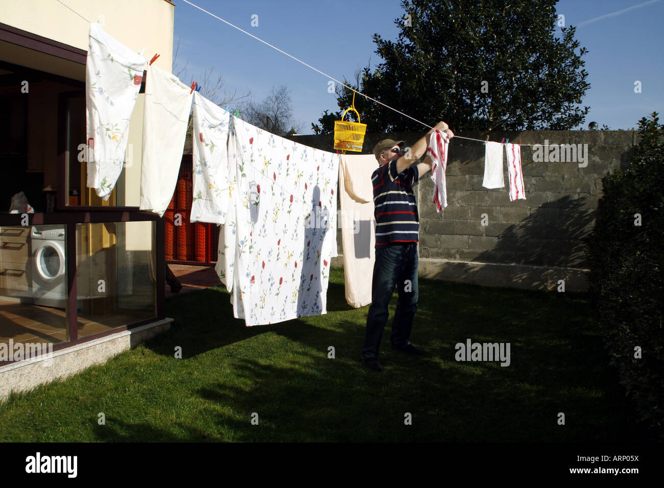 Man hanging out the washing Stock Photo