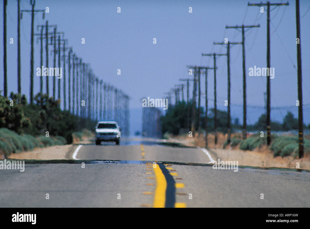 USA, California, - long shot of desert highway with telephone poles Stock Photo